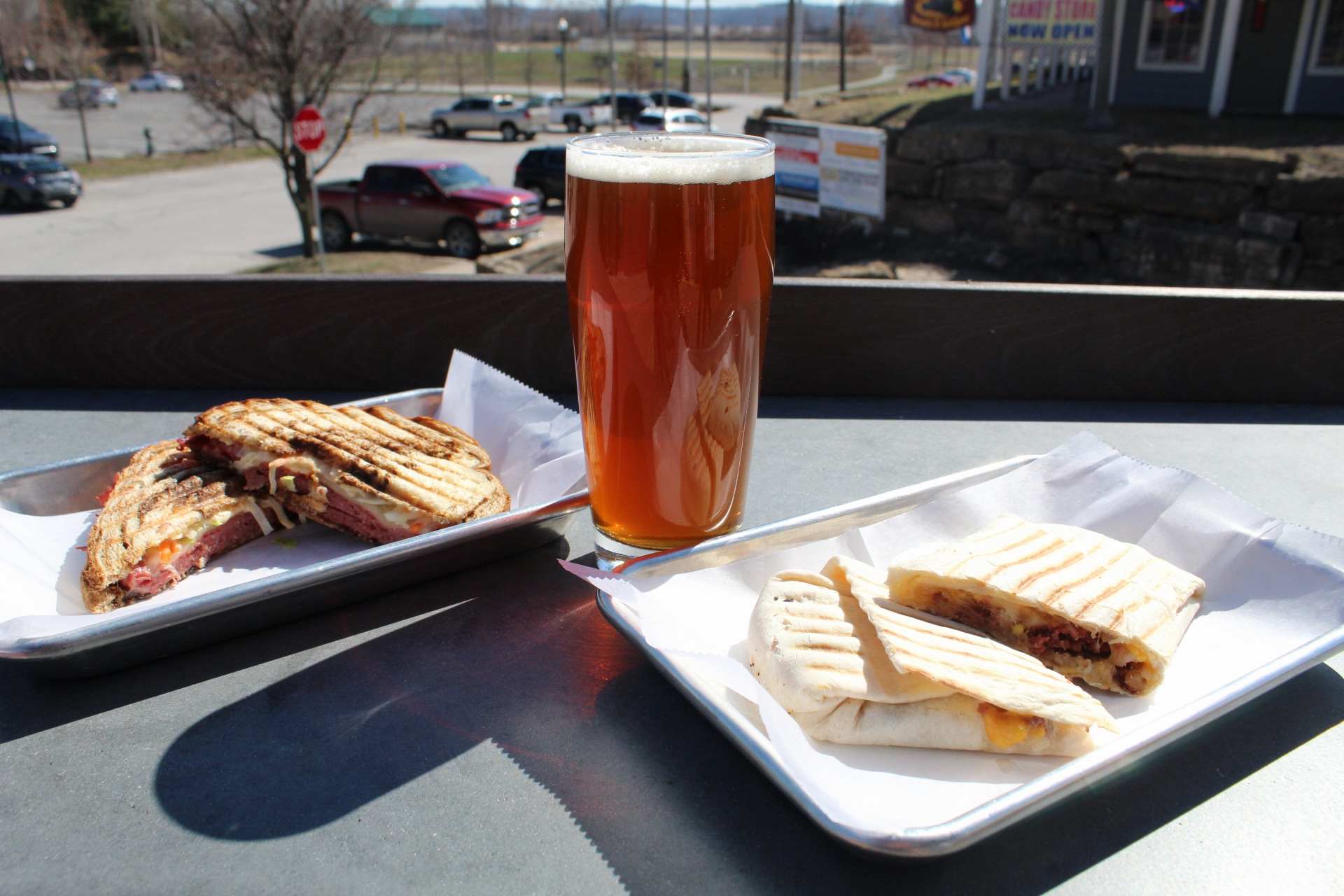 Irish Red Ale on table with Reuben Sandwich and Breakfast Burrito