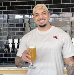 Bartender holding Rochester Tropical Sour Beer