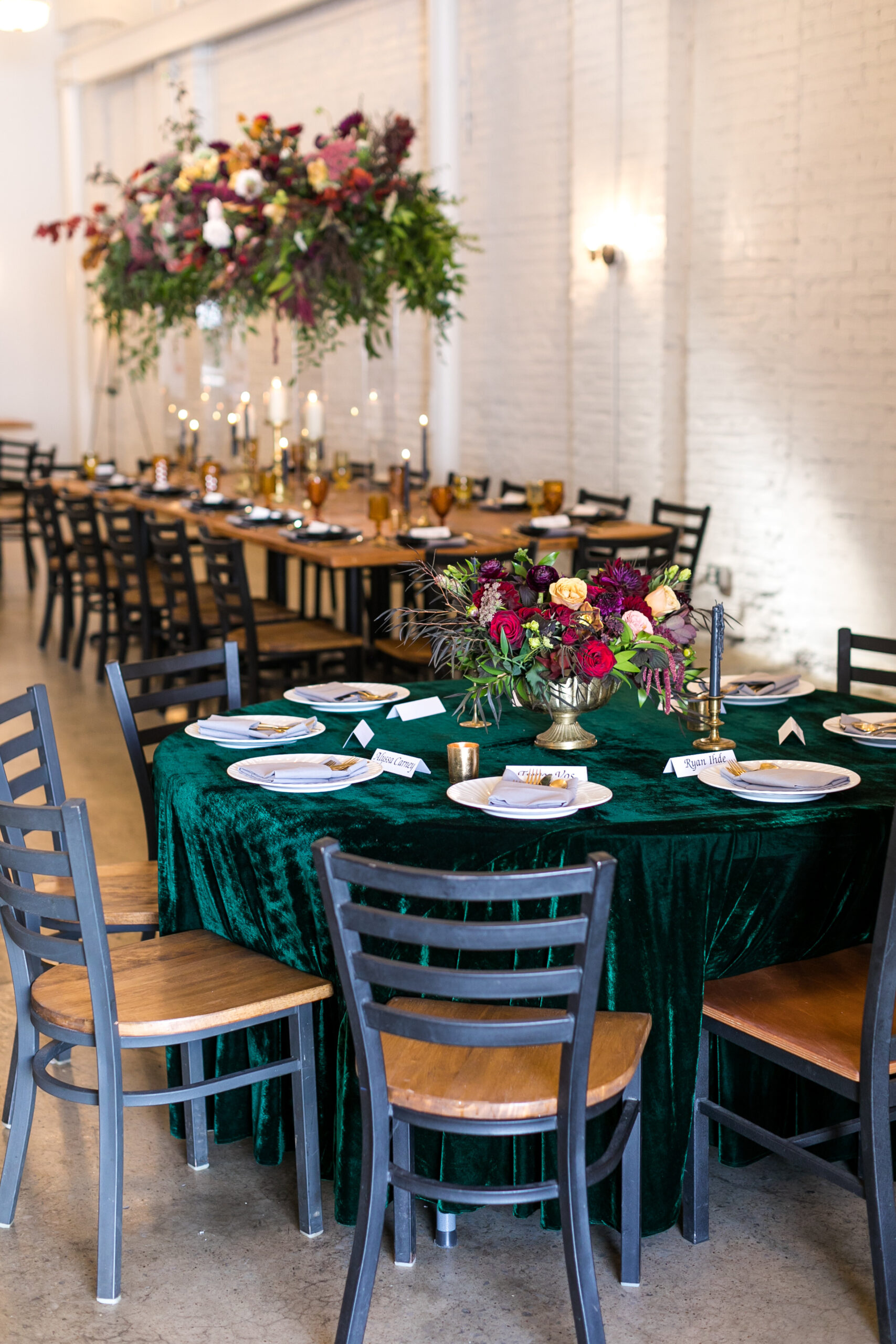 Event space with elegantly decorated round table and long table behind