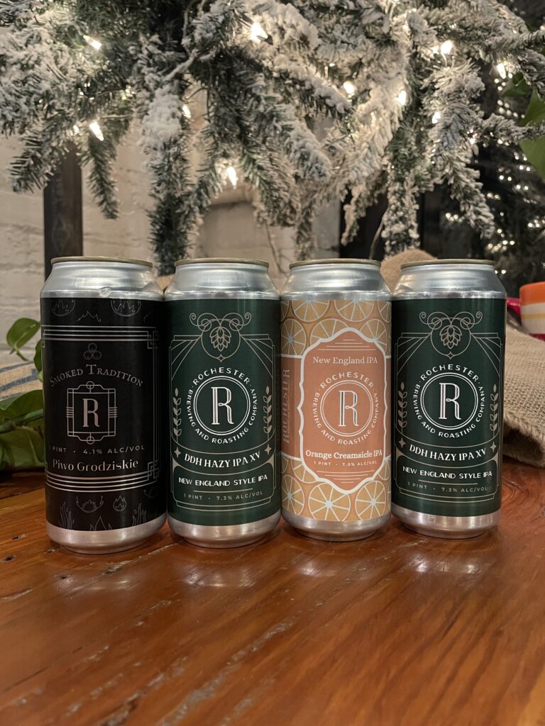 Four Rochester Beer Cans on a Wooden Bar